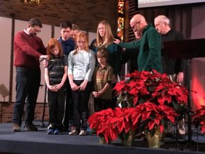 Elders of our church praying over the family